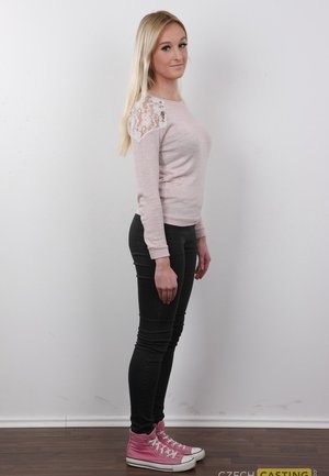 18 year old female Doris G slips off her underwear to pose naked on her bed